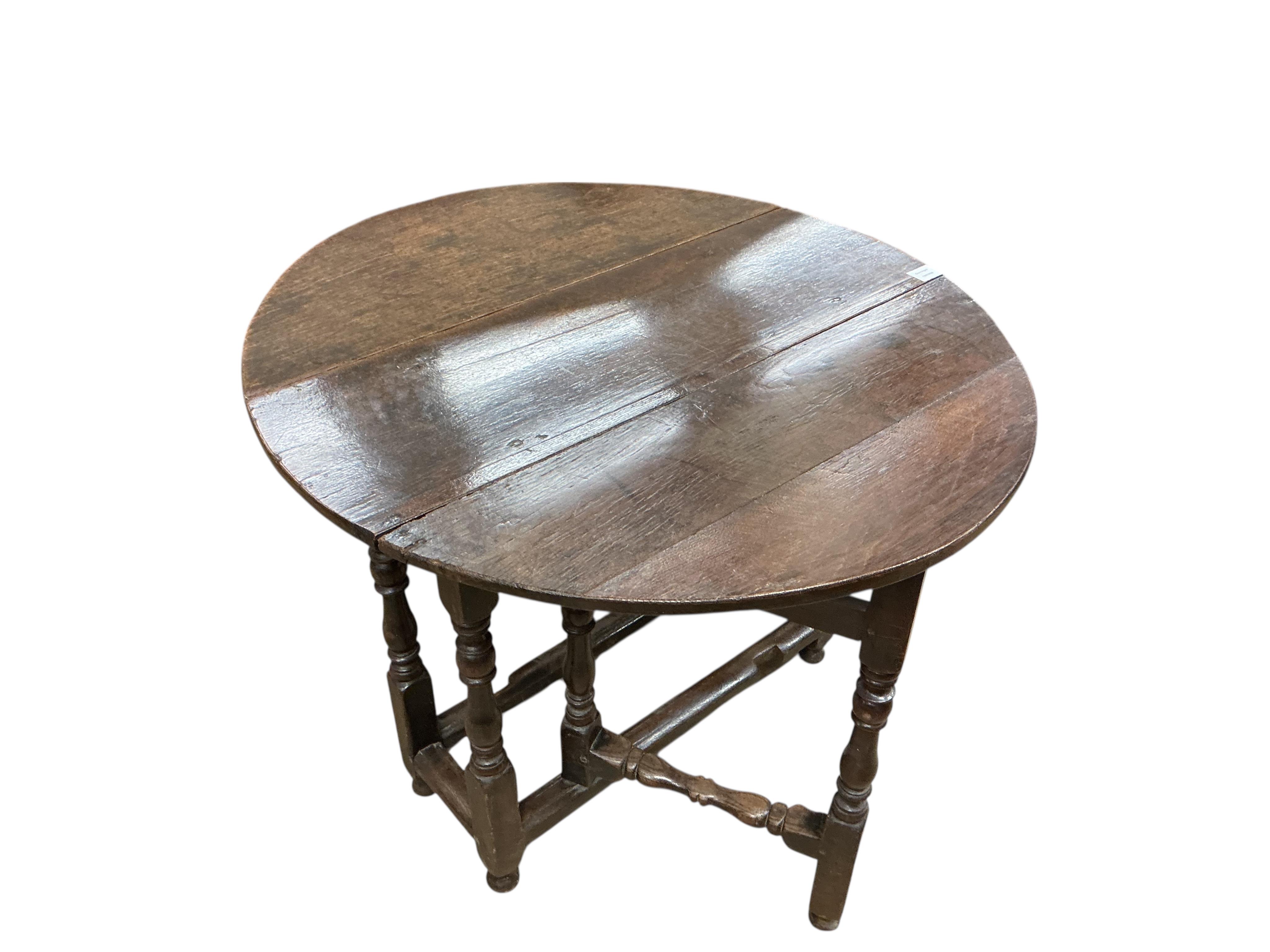 A small 18th century oval oak gate-legged table, width 92cm, depth 36cm, height 75cm